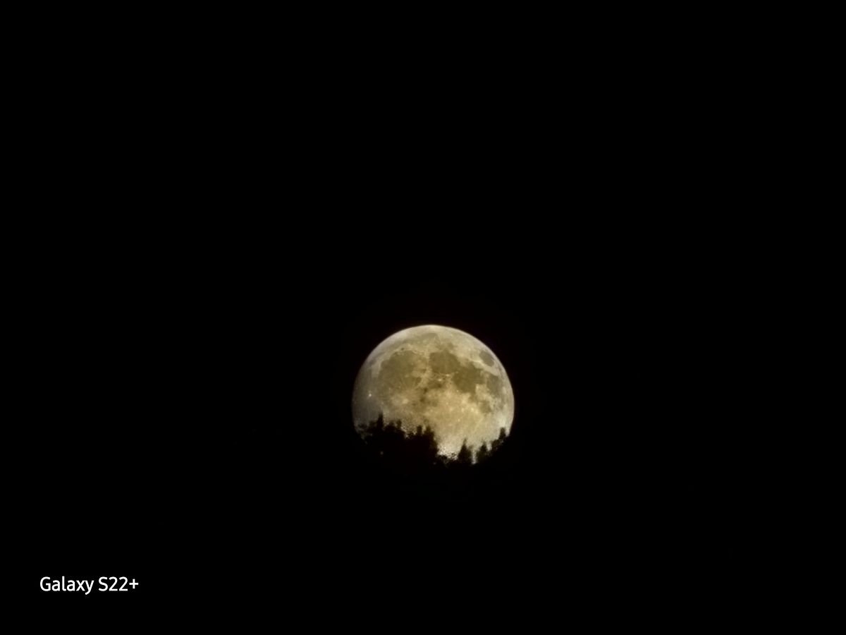 Full moon rising above the mountain top.
